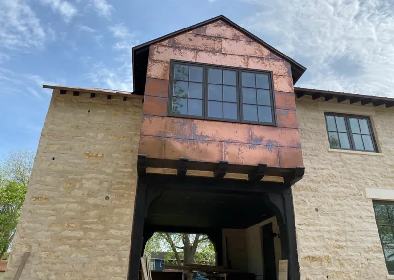 Copper metal panel facade on a stone building for Skylight Installation in Tipp City
