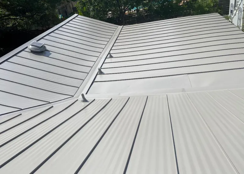 Solar attic fan installed on a metal roof for Roof Ventilation in Tipp City